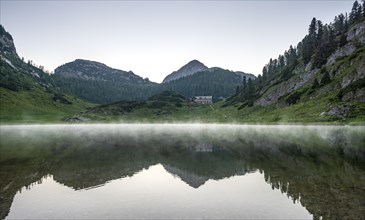 Karlingerhaus reflected in lake Funtensee in the evening