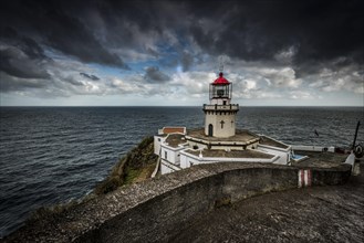 Lighthouse Farol da Ponta do Arnel at the sea