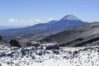 View from Mount Ruapehu on Mount Ngauruhoe with a ski cottage in the foreground. Unesco world heritage sight Tongariro National Park