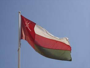 Flag of Oman waving at the mast