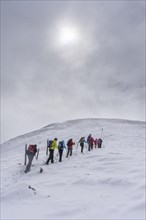 Hiking group ascending to the little Konigstuhl during fresh snowfall
