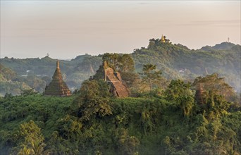 Mist over hills and stupas of Mrauk U at sunset