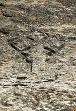Ethiopian-orthodox cross carved in stone at the orthodox rock church Mikael Mellehayzengi