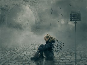 Young woman sitting on cobblestone pavement in surreal and dark fantasy street scene