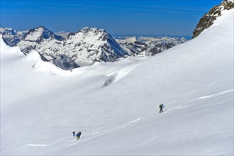 Ski tourers ascending to the summit of Aebeni Fluh