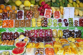 Plastic wrapped fresh fruit at a street stand