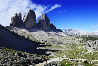 Hiker below the alpine hut in front of the northern walls of the Three Peaks of Lavaredo