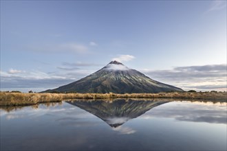 Stratovolcano Mount Taranaki or Mount Egmont reflected in Pouakai Tarn