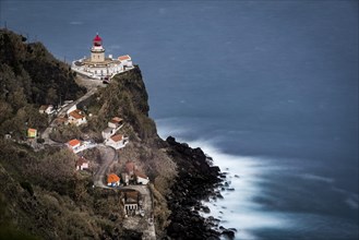 Lighthouse Farol da Ponta do Arnel with sea