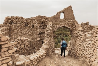 Tourist explores a ruined city