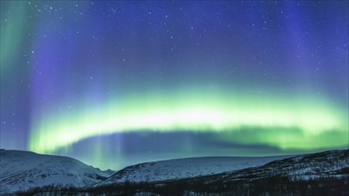 Northern Lights (Aurora borealis) over mountains