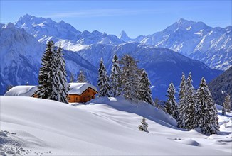 Winter landscape with deep snow-covered chalets