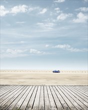 Blue VW Beetle Convertible at the beach of St. Peter-Ording