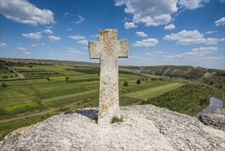 Old christian cross above the historical temple complex of old Orhei or Orheiul Vechi