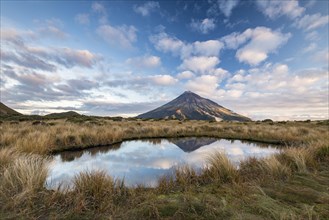 Stratovolcano Mount Taranaki or Mount Egmont reflected in Pouakai Tarn