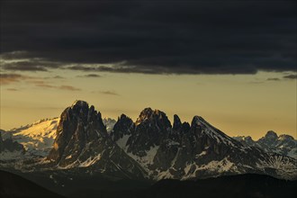 Sunrise with dark clouds over South Tyrolean mountain range