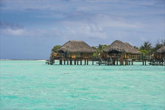 Overwater bungalows on stilts in luxury hotel