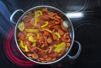 Vegetable pan on a red-hot cooktop