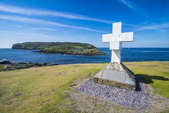 Huge cross before the small island calf of Man on the south side of the Isle of Man