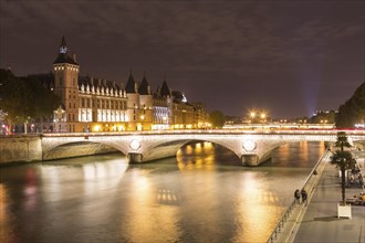 Conciergerie and Pont au Change on the banks of the Seine at night