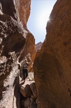 Young female hiker in a narrow sandstone canyon
