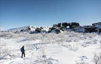 Man on hiking trail in the snow in sunshine