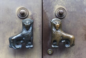 Lion figures as doorknob on door
