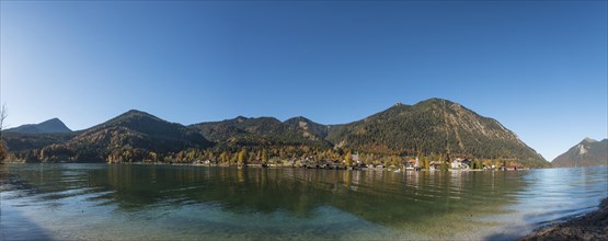 View over the lake with Jochberg and Herzogstand and place Walchensee in autumn