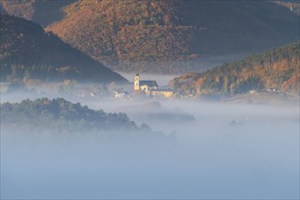 Autumn foggy atmosphere and pilgrimage church at Hafnerberg