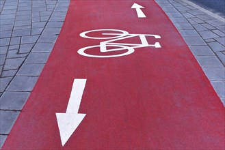 Red cycle path with white markings