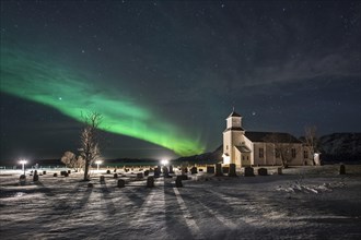 Northern lights over cemetery and church of Gimsoy