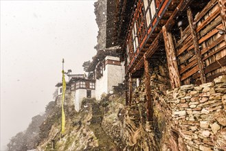 Buddhist nunnery in the mountains during snowfall