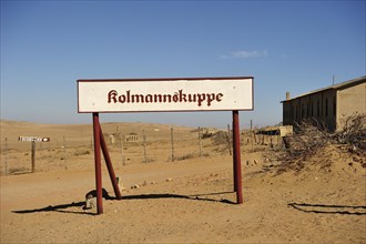 Kolmanskop sign standing in front of the former diamond town