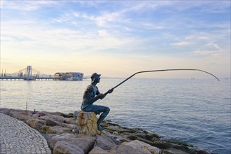 Bronze figure angler on waterfront