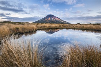 Stratovolcano Mount Taranaki or Mount Egmont reflected in Pouakai Tarn