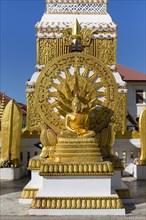 Wheel of Life and Golden Buddha Figure at the Chedi of Wat Mahathat Temple