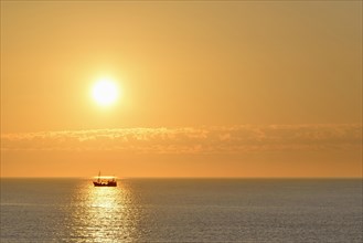 Sunset over the North Sea with fish trawler