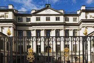 Swedish Supreme Court building with ornate black wrought iron gate with golden crown details