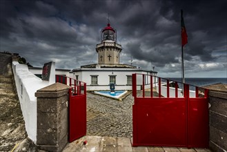 Lighthouse Farol da Ponta do Arnel at the sea