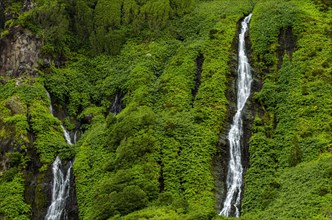 Waterfall Poco Ribeira do Ferreiro in green landscape