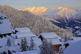 View over deeply snow-covered chalets into the Rhone valley to the Blinnenhorn 3374m and Oberrappenhorn 3176m