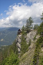 Dolomites alpine hut at a cliff