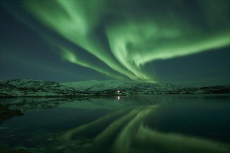 Aurora borealis with water reflection in the fjord