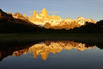 Mountain range with Cerro Fitz Roy at sunrise reflected in Lago de Los Tres