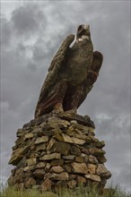 Golden eagle made of stone along the road