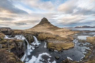 Kirkjufell mountain with Kirkjufellfoss waterfall at sunset