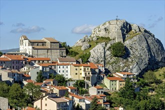View of mountain village Pietrabbondante with medieval tower and church Chiesa di Santa Maria Assunta on rock Morg Caraceni
