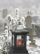 Grave lantern and hoarfrost at the cemetery