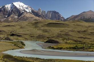 Snow covered peaks of the granite mountains Torres del Paine with the Rio Paine glacial river