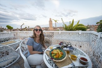 Young woman on a roof terrace in the restaurant